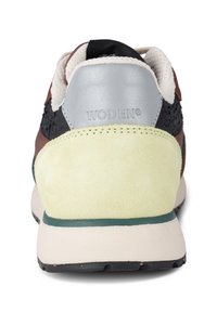 Men's sneaker featuring a multicolor design, suede and mesh materials, with a yellow and black heel, and a prominent WODEN logo.