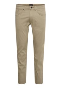 Pantalons slim beige en mélange de coton avec une texture lisse. Dispose de cinq poches, d'une fermeture à bouton et de coutures discrètes.