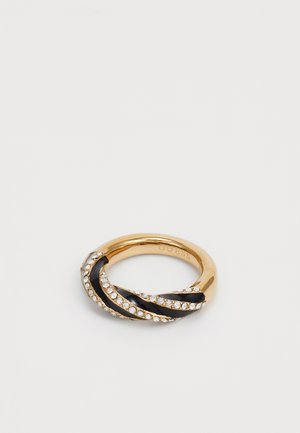 Gold-tone ring with intertwined black accents and a row of clear crystals. Smooth texture, round shape, and subtle branding on the interior.