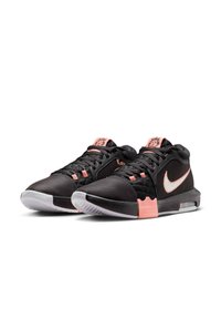 Black athletic sneakers with a textured upper, white swoosh, pink accents, and a visible air cushioning unit on the sole.