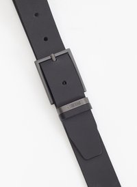 Cinturón de cuero negro con una hebilla de metal negro brillante, que cuenta con agujeros ajustables y una textura suave. Logo impreso en la hebilla.