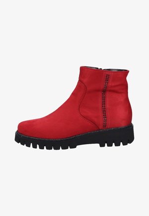 Red suede ankle boot with a textured finish, black chunky sole, side zipper, and decorative studs along the seam.