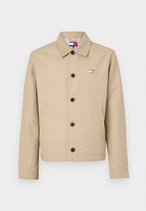 Beige cotton jacket with a collared neckline, front buttons, and side pockets. Features a small emblem on the chest and a striped inner lining.