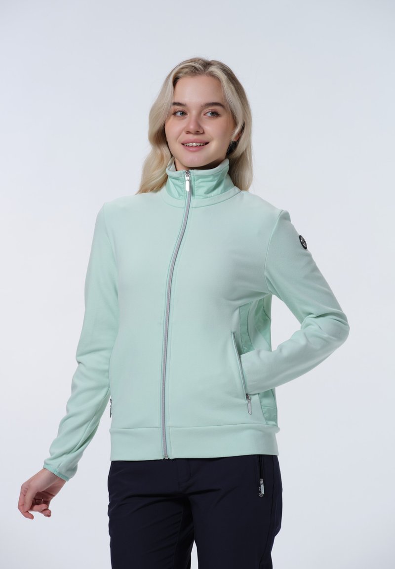 Ljus mintgrön zip-up-jacka gjord av mjukt material med hög krage, två sidofickor och silverfärgade detaljer.