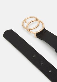 Black leather strap with a circular gold metal buckle featuring two intertwined rings. Smooth texture, minimal design, three adjustment holes.