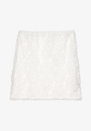 White decorative pillow cover with textured circular ruffle pattern; soft fabric creates a plush appearance. Edges are neatly finished.