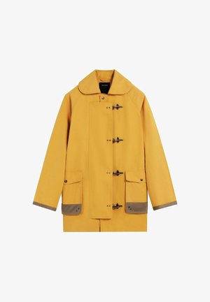 Yellow raincoat with a large collar, toggle fastenings, two front pockets, and brown accents at the cuffs and pockets. Smooth fabric texture.
