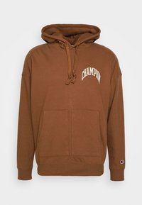 Sudadera marrón con capucha hecha de mezcla de algodón. Cuenta con un bolsillo frontal tipo canguro y el logo blanco de "Champion" en el pecho. Puños acanalados.
