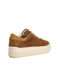 Brown suede sneaker with a textured cream rubber sole, rounded toe, and contrasting tan heel accents. Features lace-up design and minimal branding.
