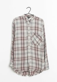 Checked long-sleeve shirt in gray, pink, and white. Features a collar, six buttons, a chest pocket, and a frayed hem at the bottom.