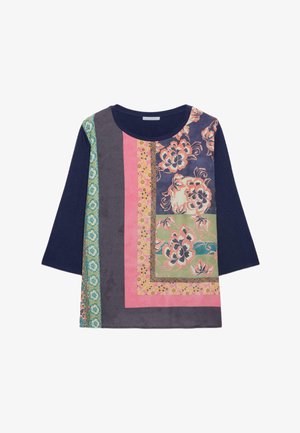 Haut à manches longues bleu marine avec un design en patchwork comprenant des motifs floraux et des rayures verticales dans des tons de rose, vert et gris.