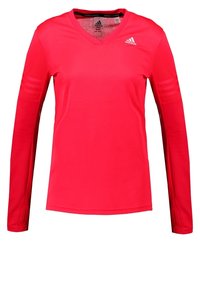 Rød langærmet atletisk skjorte med V-hals og teksturerede detaljer på ærmerne. Lavet af letvægtsstof med Adidas-logoet på brystet.