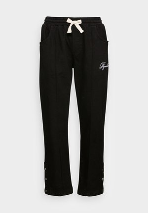 Pantalon décontracté noir avec cordon blanc, poches latérales, poignets boutonnés et texte brodé blanc sur la cuisse droite.