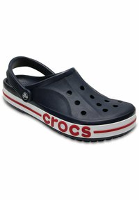 Navy blue clogs with ventilation holes, a back strap, and a white/red accent band featuring the word "crocs" in bold letters.