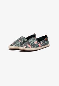 Floral slip-on shoes with a dark background, featuring green leaves and pink flowers. Jute-like outsole and black interior lining details.