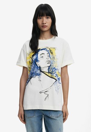 White cotton t-shirt featuring a blue and yellow graphic illustration of a face. Short sleeves with a relaxed fit and round neckline.