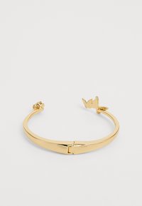 Gold-tone metal cuff bracelet with a smooth finish, featuring a subtle clasp and decorative leaf and flower accents on each end.
