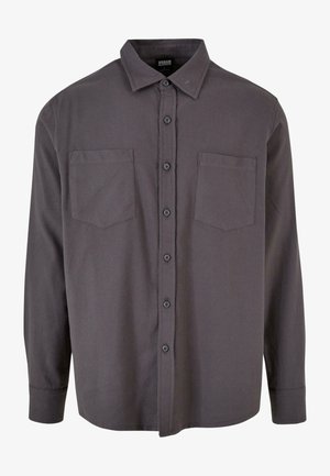 Szürke, hosszú ujjú, gombos ing gallérral, két mellzsebbel és egyenes szegéllyel. Puha, szövött anyagból készült.