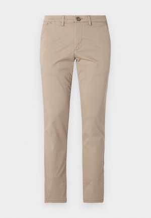 Pantalon beige en coton, avec une coupe plate, fermeture à bouton et design slim. Texture lisse avec poches latérales.