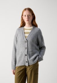 Gray wool cardigan with a V-neck, five brown buttons, and two front pockets. Paired with a green and white striped shirt.