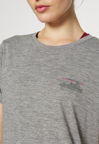 Gray heathered t-shirt with short sleeves, round neckline, and a small black graphic of mountains with red and blue accents.