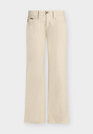 Beige jeans med vide ben, frontknapper og lynlås, for- og baglommer samt bæltestropper, vist på en ensfarvet baggrund.