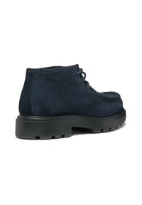 Stivaletti alla caviglia in suede blu navy con suola piatta in gomma nera, punta rotonda e design con lacci. Presentano delicati dettagli di cucitura.