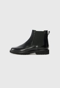 Black leather Chelsea boot with elastic side panels, rounded toe, and textured rubber sole. Features a pull tab on the back.