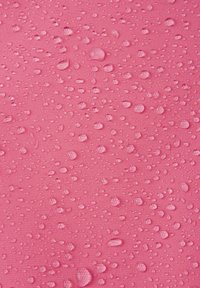 Pink textured surface with numerous water droplets of varying sizes, showcasing a smooth and slightly glossy finish.