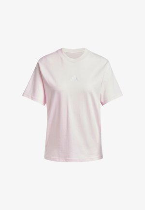 T-shirt in cotone rosa con collo a giro, maniche corte e un piccolo logo ricamato bianco sul petto. Design semplice e uniforme, texture morbida.