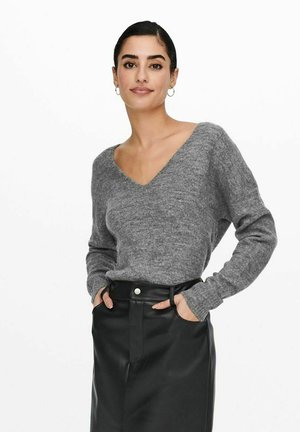 Gray knitted sweater with a V-neck and long sleeves, paired with a black leather skirt. The fabric appears soft with a textured finish.