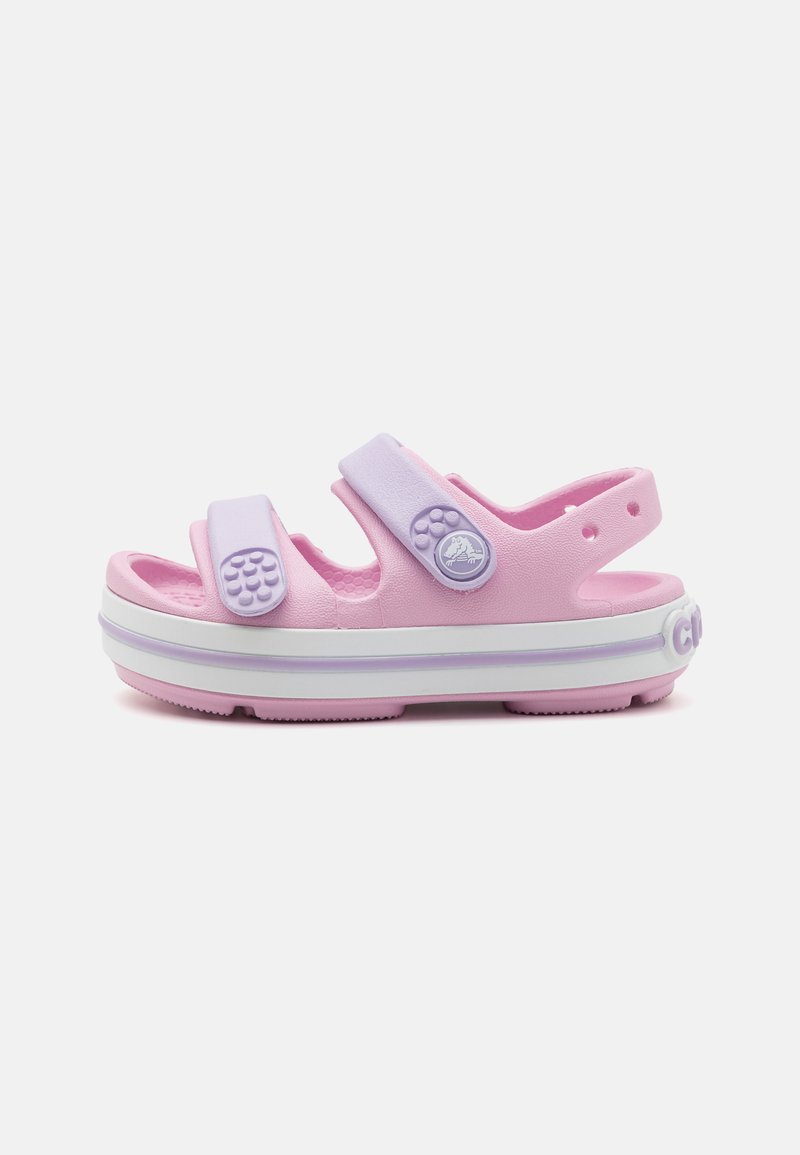 Pink sandal with two purple adjustable straps, textured footbed, and a white midsole. Features a circular design accent and perforations.