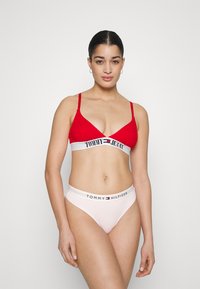 Červený bralet s bielym označeným pásom; priehľadné ružové slipy s bielym a čiernym logom na páse; hladká zmes bavlny.
