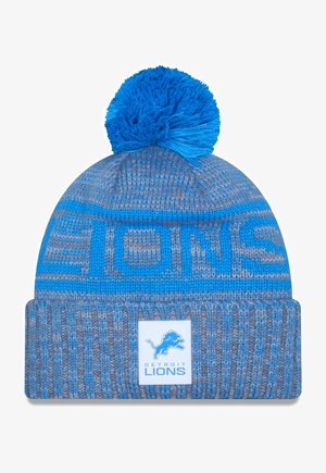 Blue knit beanie with a pom-pom at the top, featuring a textured design and a folded cuff displaying "DETROIT LIONS" and a logo.
