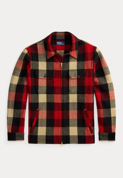 Red, black, and beige plaid flannel jacket with a front zipper, two chest pockets, and side pockets. Features a pointed collar and textured fabric.