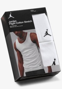 Two-pack of white cotton tank undershirts with a smooth texture, featuring black Jordan logo accents on the neckline and packaging.