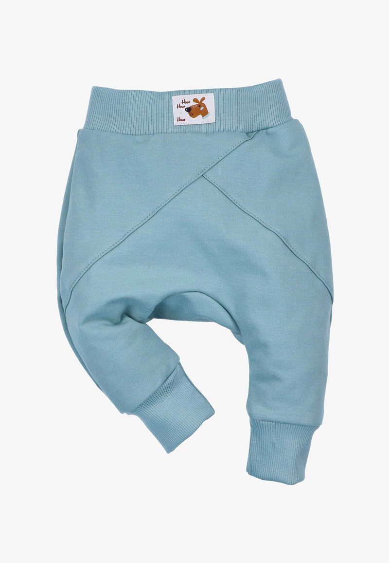 Pantalons de jogging bleu clair avec une texture douce, présentant un design croisé à la taille, des poignets ribbés et une petite étiquette de marque.