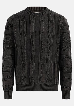 Svart tröja med en texturerad yta som har upphöjda, vågiga mönster. Ribbad rundad halsringning och ärmslut, vilket ger en åtsittande silhuett.