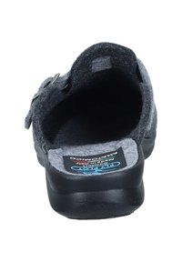 Gray felt shoe with a black rubber sole, featuring an adjustable strap and textured interior. Logo visible on the insole.