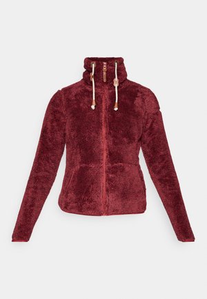 Bordo zip-up flisjakna s visokim ovratnikom, teksturiranom tkaninom i kremastim vezicama s bež detaljima. Ima dva prednja džepa.