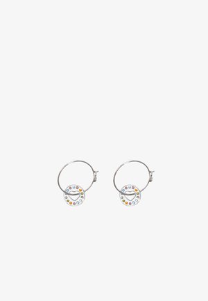 Silver hoop earrings featuring circular pendants with a heart design, surrounded by colorful rhinestones in varying sizes.