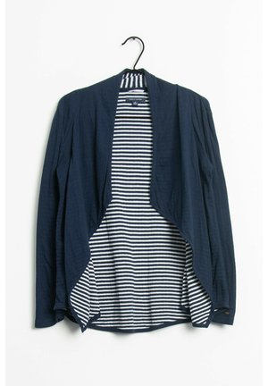Cardigan ouvert bleu marine à manches longues, avec un intérieur rayé blanc et bleu marine. Tissu léger avec une coupe décontractée et un ourlet arrondi.