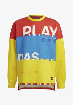 Bluza z długim rękawem z czerwonymi, niebieskimi i żółtymi blokami przypominającymi klocki LEGO oraz częściowo widocznym słowem „PLAY” z przodu.