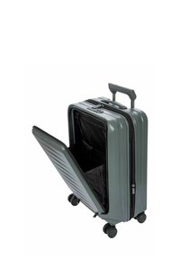 Valise rigide de couleur gris foncé avec un extérieur strié. Elle est équipée d'une poignée rétractable, de quatre roues et d'un compartiment ouvert révélant un intérieur noir.