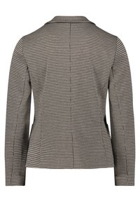 Blazer à motif pied-de-poule en noir et beige, au design structuré, avec des manches longues, un col en trou de serrure et une coupe ajustée avec des pinces au dos.