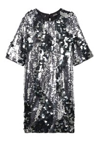 Robe en sequins argentés et noirs avec manches courtes, encolure ronde et coupe ample. Dispose d'une surface brillante et texturée avec des sequins circulaires.