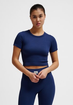 Navy blue ribbed crop top with short sleeves, round neckline, and a snug fit, paired with matching ribbed leggings. Minimal branding detail visible.