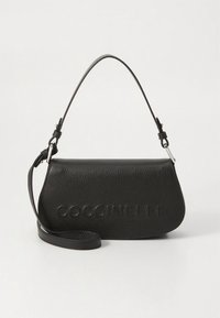 Black leather shoulder bag with a curved shape, embossed logo on the front, adjustable strap, and textured surface for grip.