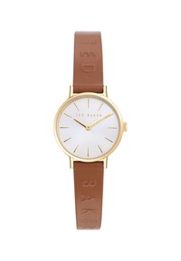 Montre ronde avec un boîtier en or, un cadran blanc et un bracelet en cuir marron avec un logo embossé sur la sangle. Design minimaliste et marquages.