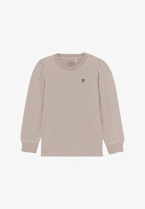 Lys beige langærmet skjorte lavet af blødt bomuld. Har rund hals, sammenfoldet skulderdetalje og en lille mørk hjerteaccent på brystet.